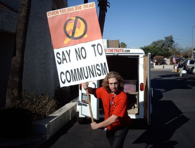 Radio station employee with 'Say No To Communism' sign