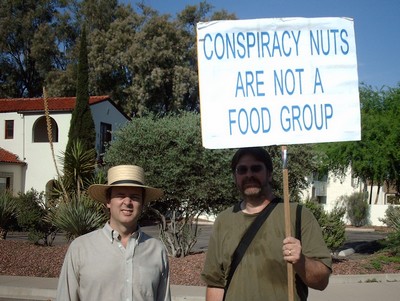 9/11 Truther and author with 'Conspiracy Nuts Are Not A Food Group' sign