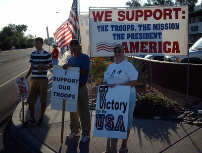 Troop support people with banners and signs