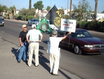 Two protesters and a troop supporter in street